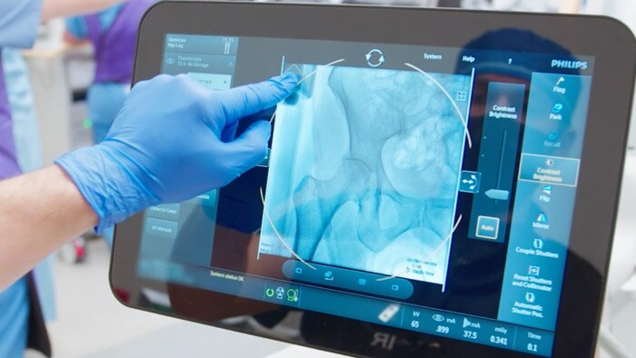 Surgeon using touchscreen during surgery